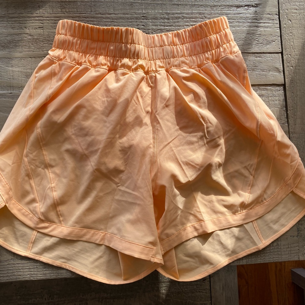 Track that high rise 5 inch shorts. Never worn but washed summer glow size 6.